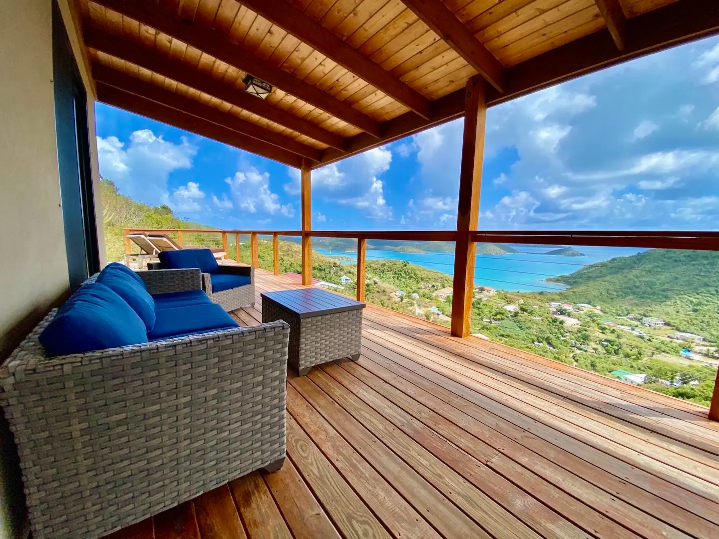 Outdoor terrace featuring comfortable seating, overlooking the breathtaking Coral Bay.