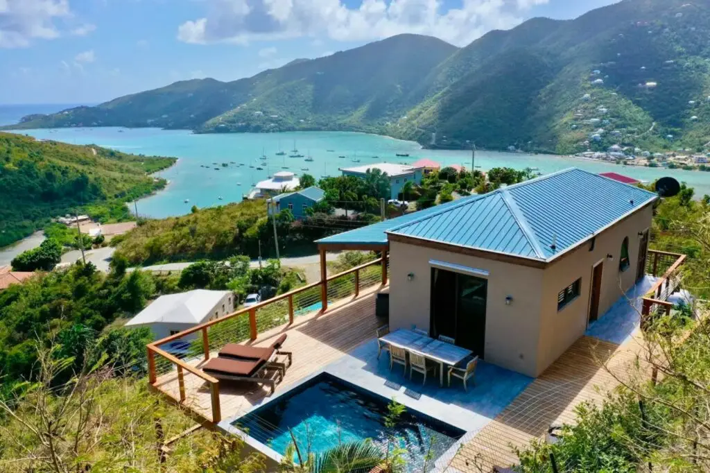 Scenic mountain view from the house, featuring a rooftop pool and a stunning beach in Coral Bay.